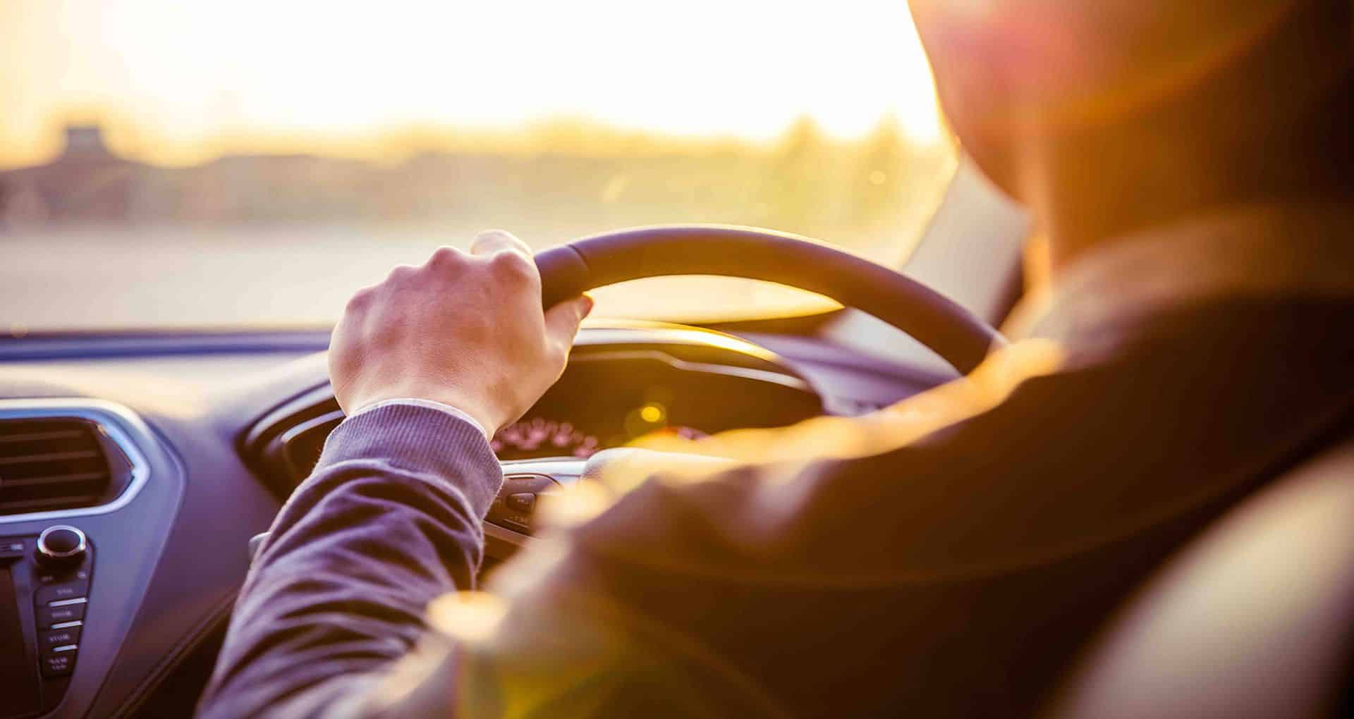 A man in the driver's seat of his vehicle