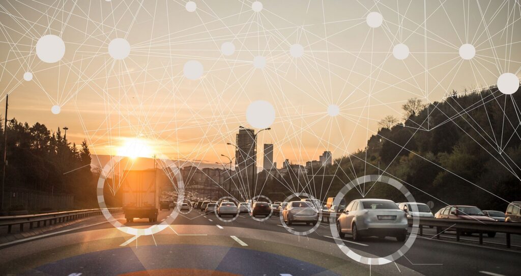 A busy highway full of cars and trucks connected by digital nodes