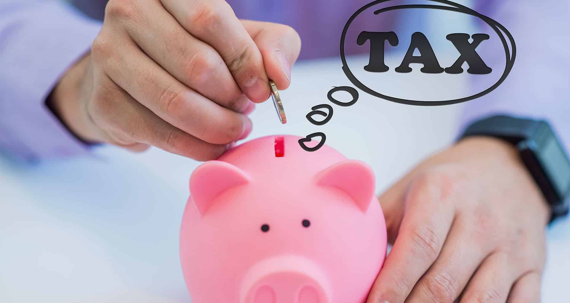 A man putting coins into a piggy bank