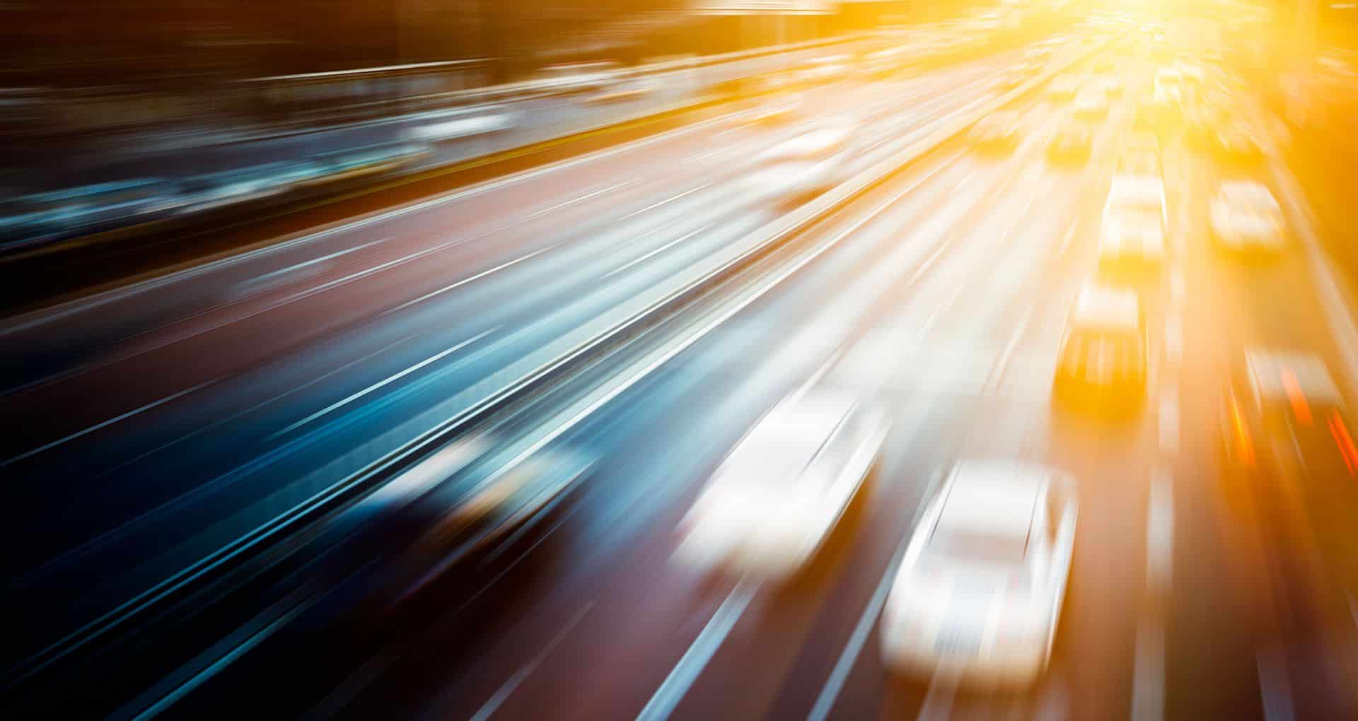 A bunch of cars speeding down the highway