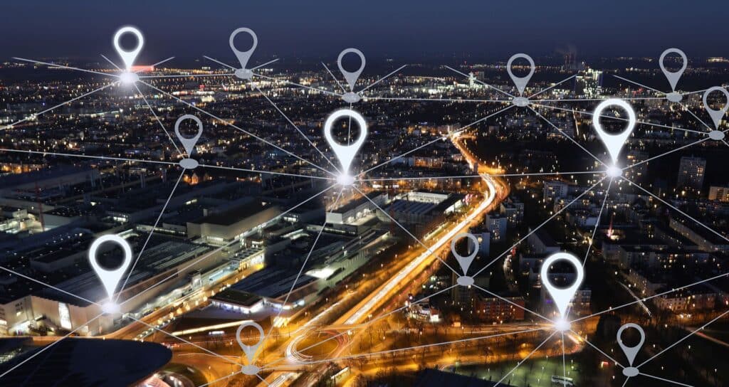 Birds-eye shot of a city at night connected by a series of digital nodes