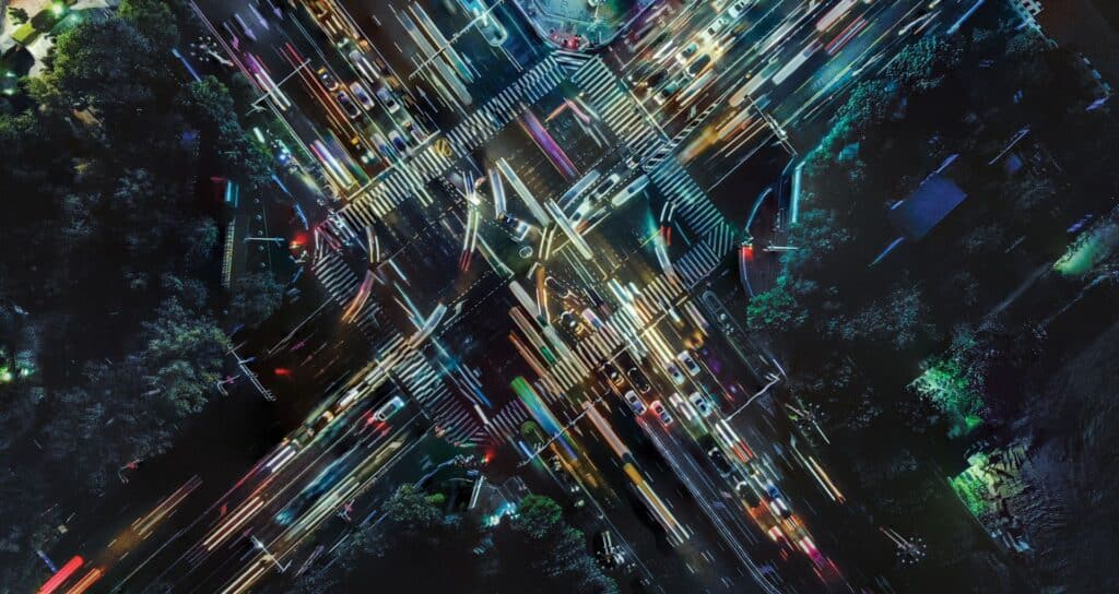 Overhead long exposure photo of a busy intersection at night
