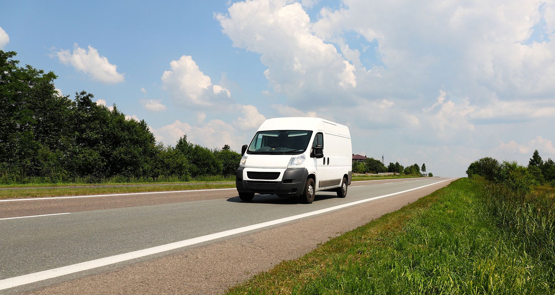 A van driving down an empty country road